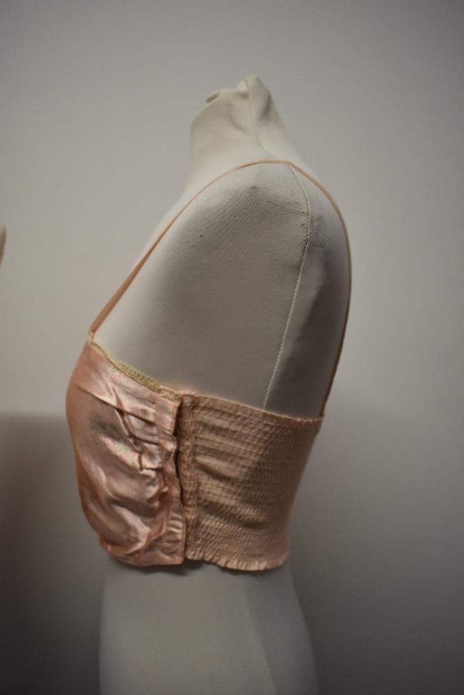 A 1940s strapless pink satin finish bra and a 1920s bralette with shirred back. - Image 3 of 10