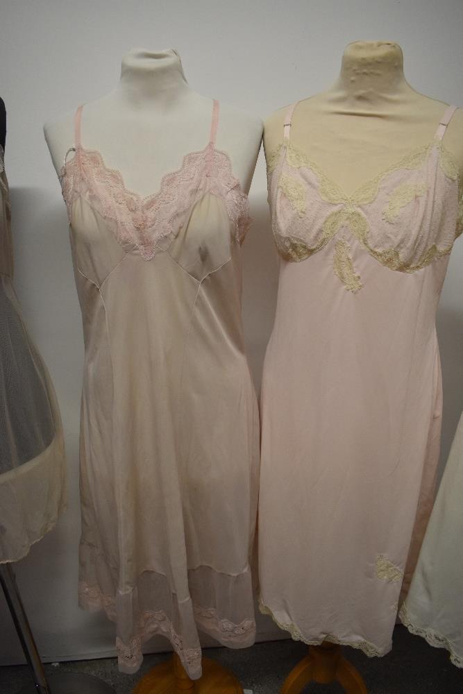 Five 1950s and 1960s sheer and semi sheer nylon slips, all having lace, medium to large sizes. - Image 2 of 12