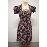 A 1950s floral cotton Dirndl style dress, having puff sleeves, fairly full skirt and buttons to