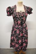 A 1950s floral cotton Dirndl style dress, having puff sleeves, fairly full skirt and buttons to
