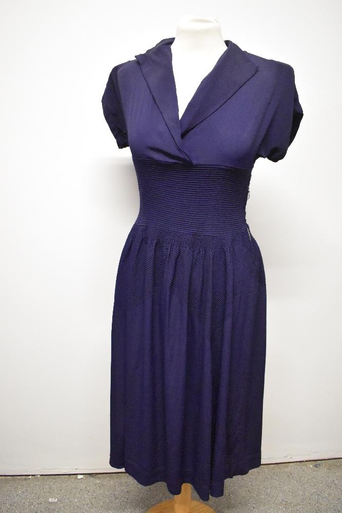 A striking 1940s navy blue floppy crepe day dress, having pointed cross over collar and tiny ribs of