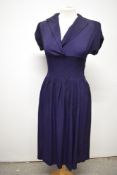 A striking 1940s navy blue floppy crepe day dress, having pointed cross over collar and tiny ribs of