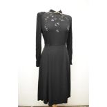 An unusual 1930s/40s day dress of black crepe with floral cut work to bodice and sleeves, lace