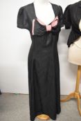 A 1930s Art Deco taffeta dress with pink and black statement bow to bust and a black watered taffeta