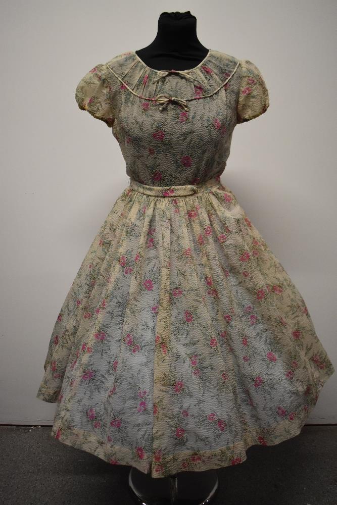 A Late 1940s semi sheer seersucker day dress, having delicate floral sprig pattern, scoop neckline