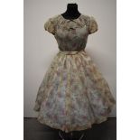 A Late 1940s semi sheer seersucker day dress, having delicate floral sprig pattern, scoop neckline