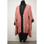 An early 20th century reversible kimono dressing gown, having rose pink ground with lake and
