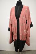 An early 20th century reversible kimono dressing gown, having rose pink ground with lake and