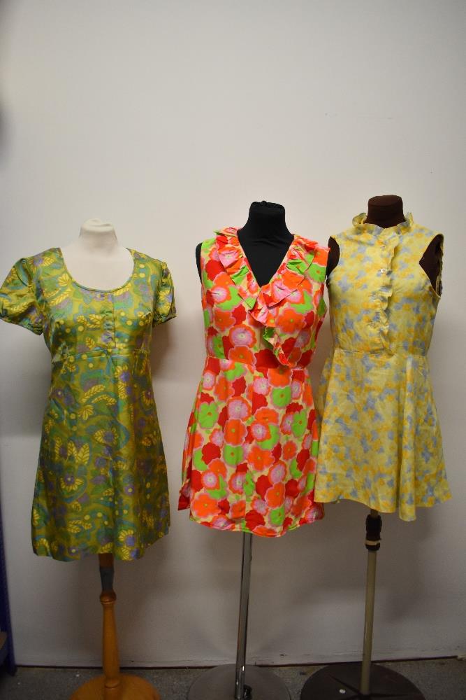 Three vintage 1960s brightly patterned mini dresses.