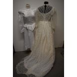 A 1970s nylon wedding dress with long train, full length sleeves and high neckline and a 1980s