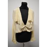 An Edwardian cream silk blouse, having large statement collar edged with lace and blouson bodice,