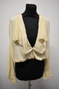 An Edwardian cream silk blouse, having large statement collar edged with lace and blouson bodice,