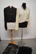 An early 20th century black blouse with fancy red buttons and embroidery to collar, a 1960s cream St