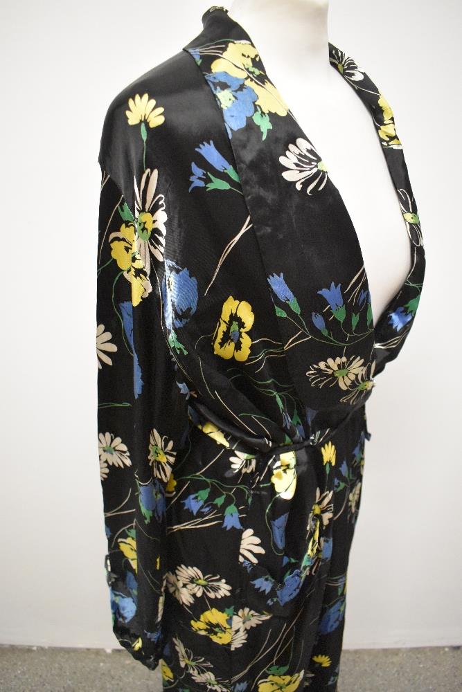 A 1940s glossy black rayon house coat, having vibrant floral pattern, very satin like to the touch. - Image 5 of 7