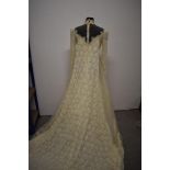 An unworn vintage American wedding dress, Rayon and Nylon blend, having high neckline, long sleeves,