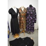A mixed lot of 1960s and 1970s clothing, to include; three blouses, a floral pleated dress, a floral
