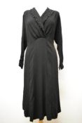 A 1930s black crepe day dress, having cut work to collar, panelled skirt and long sleeves, larger