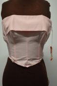 A dead stock 1950s pale pink boned sun top, with hook and eye fastening to back, having original '