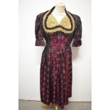 A late 1940s/ early 50s Dirndl style dress in burgundy, olive and leaf green, having pleated
