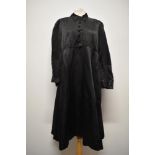 A 1920s/30s black silk or silk blend smock dress, having long sleeves with gathered cuff, pin