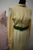 Three vintage 1960s dresses, to include; early 60s pink wiggle dress, cream maxi dress with green