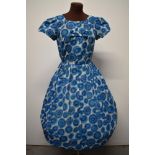 A blue 1950s day dress, having side metal zip, fairly full pleated skirt and bow detail to
