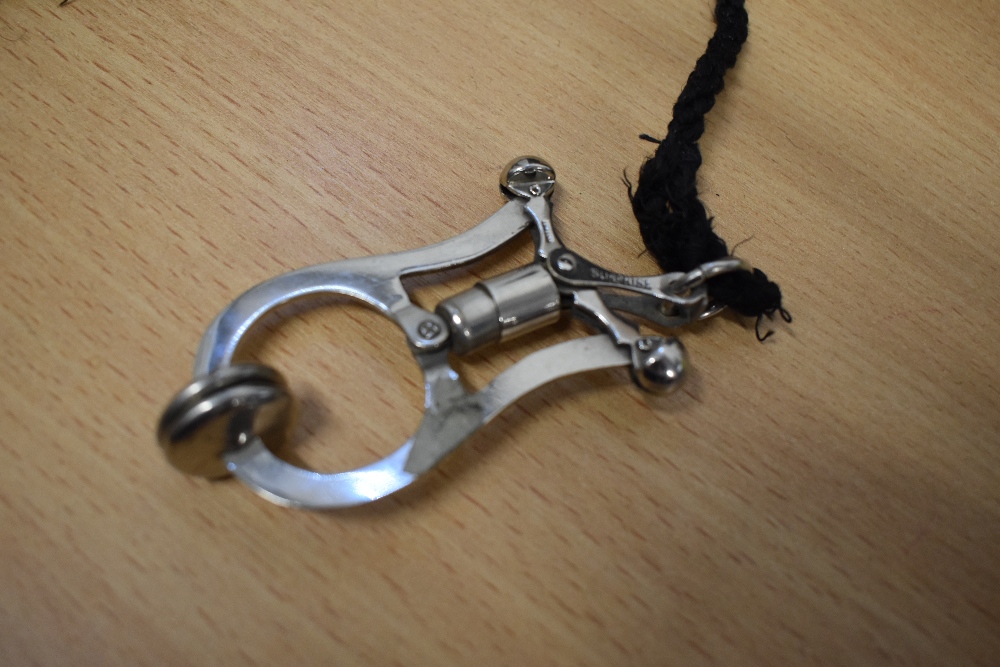 An early 20th century 'Sunrise' stainless steel skirt lifter on lanyard. - Image 2 of 3