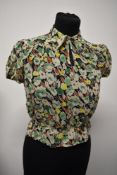 An Art Deco sheer floral crepe blouse, having shirred waist, pointed collar and button fastening.