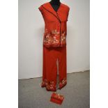 A set of mid century Japanese pyjamas of red silk with bright floral design, consisting of top and