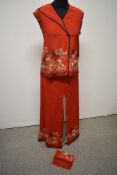 A set of mid century Japanese pyjamas of red silk with bright floral design, consisting of top and