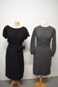 Two 1950s wiggle dresses, one having beading to bodice and bow to gathers at hip, the other of