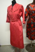 A late 1940s cerise taffeta dress having amazing novelty buckle details to shoulders, pockets to