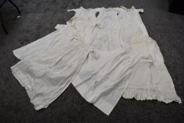 A box of ten early 20th century infant a young child's garments, some pretty details to some of