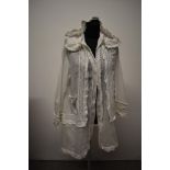 A Victorian lawn cotton hooded bed jacket, having drawstrings to hood, buttons to front, pockets,