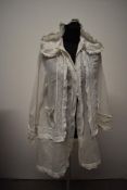 A Victorian lawn cotton hooded bed jacket, having drawstrings to hood, buttons to front, pockets,