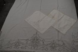 A Victorian linen sheet and two pillowcases, having extensive lace, cutwork and embroidery, around a
