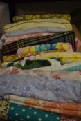 A box full of vintage and retro bedding, towels, a table cloth, a travel rug and similar.