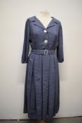 A 1950s slate blue dress with white fleck running throughout, shawl collar, buttons to front,