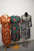 Three vintage dresses, comprising; 1970s burnt orange floral dress. Blue late 1950s/ 1960s dress and