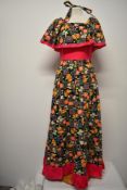 A vibrant 1960s cotton maxi dress, with amazing shawl collar, ruffled hem and rear metal zip and