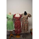 A 1940s cotton day dress, having crimson floral pattern with Ric-Rac detailing and the other floral,