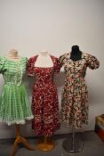 A 1940s cotton day dress, having crimson floral pattern with Ric-Rac detailing and the other floral,