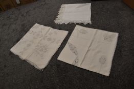 Three highly decorative antique tablecloths, including linen and damask.