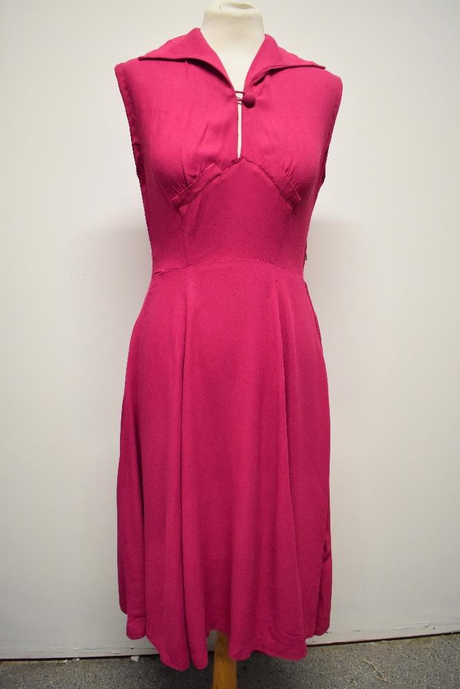A 1940s cerise crepe dress, having button to bodice, side metal zip and fairly full panelled skirt.