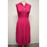 A 1940s cerise crepe dress, having button to bodice, side metal zip and fairly full panelled skirt.