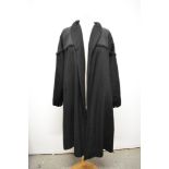 A 1950s black swing coat, having brocade and grosgrain detail to shoulders and collar, some historic
