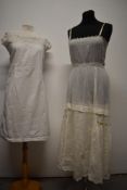 An Edwardian lawn cotton slip, having hand embroidery, scalloped hem, ladder work and ribbon woven