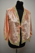 A decadent 1930s Art Deco bed jacket of pale pink velvet, having extensive lace edging, pointed