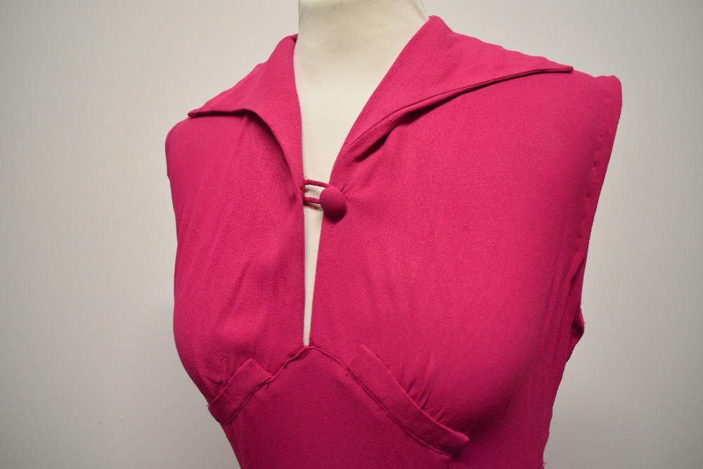 A 1940s cerise crepe dress, having button to bodice, side metal zip and fairly full panelled skirt. - Image 6 of 7