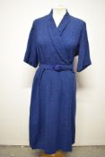 A late 1940s/50s day dress of medium weight fabric in blue with grey fleck, with belt, larger size.